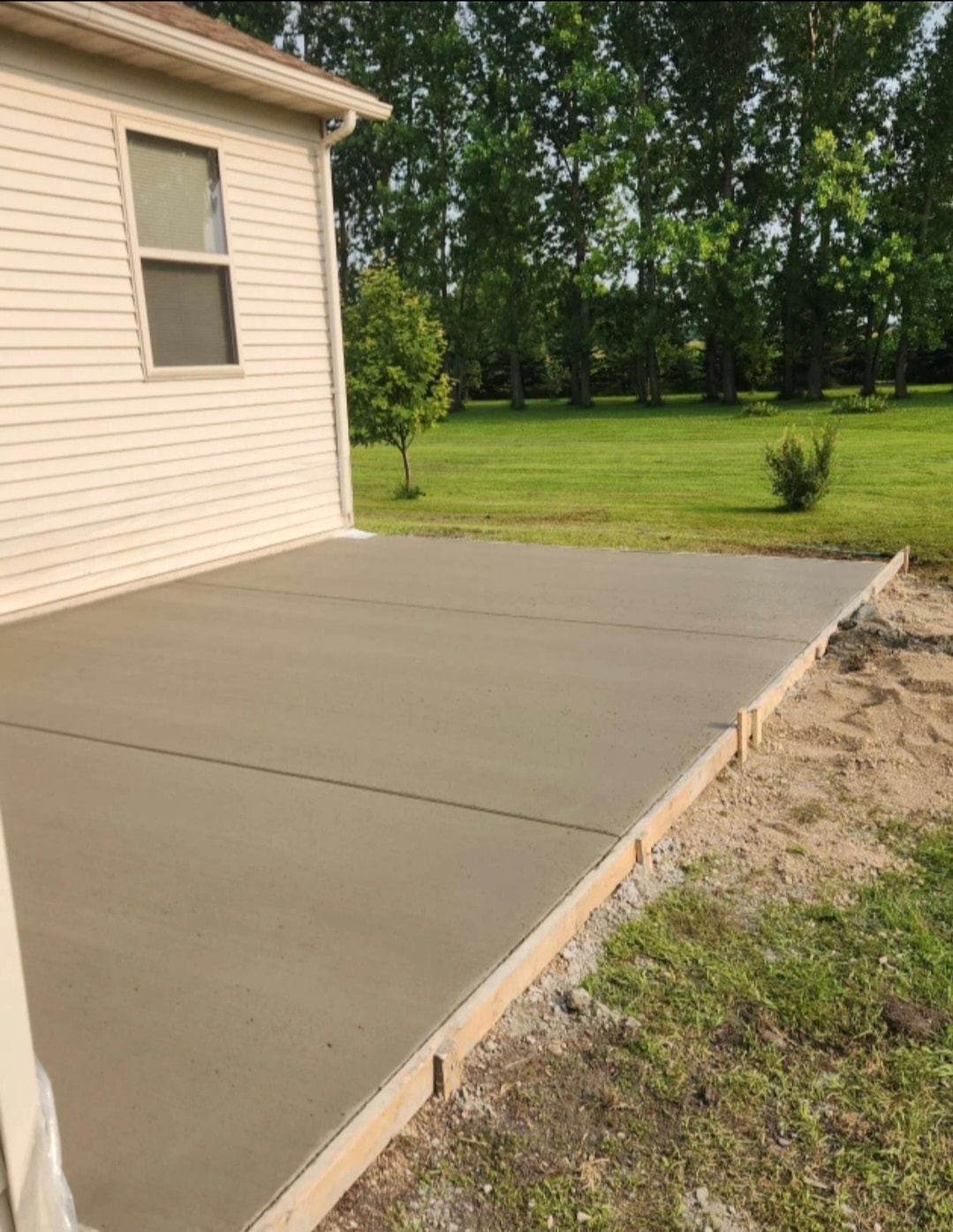 Finished concrete patio beside residential home